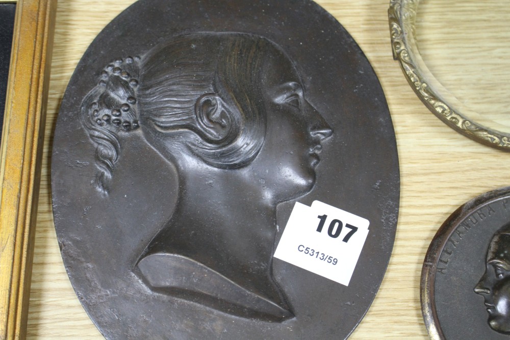 A Victorian bronze relief plaque of the young Queen Victoria, height 25cm, a bronzed metal plaque of Alexandra Princess of Wales with